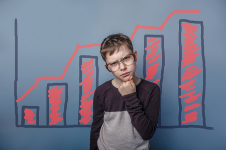 boy teenager European appearance Brown turned his back on a black backgroundの写真素材