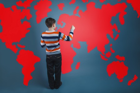 boy teenager European appearance Brown turned his back on a black backgroundの写真素材