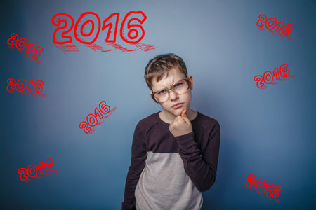 boy teenager European appearance Brown turned his back on a black backgroundの写真素材