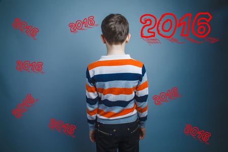 boy teenager European appearance Brown turned his back on a black backgroundの写真素材