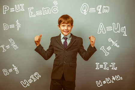 Teen boy genius gesture joy physics formulas around the photo studio retro