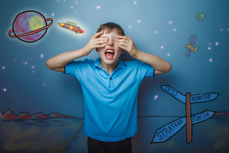 boy teenager European appearance Brown turned his back on a black backgroundの写真素材