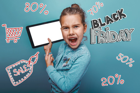 teen girl Black Friday discount sale shopping He screams to the tablet showsの写真素材