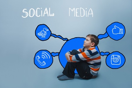 boy frowning sitting on the floor looking up thinking social media infographics sketch Internetの写真素材