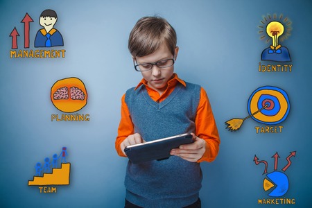 boy with glasses working on a tablet thoughtful collection of business icons management team goal sketchの写真素材