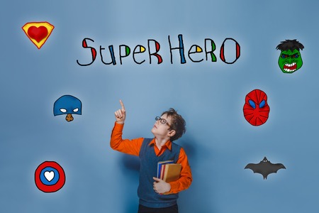 Retro boy teenager shows his hand up to the superhero super power of the photo studio Icons heroの写真素材