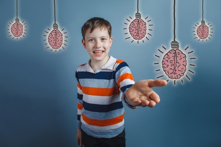 adolescent boy laughing and held out his hand forward gesture of friendliness brain bulb creative ideaの写真素材