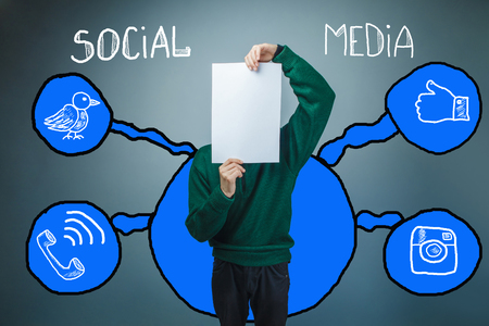 Teen boy covered his face with a piece of paper sketch social media infographics Internetの写真素材