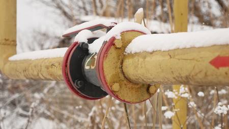yellow gas pipe in snow winter gas heatingの写真素材