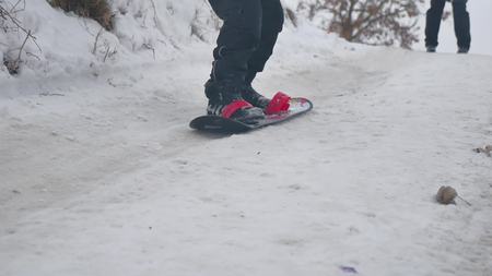 boy snowboarding in the snow with a winter holidaysの写真素材
