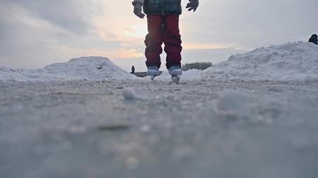 teen girl skating on ice, winter sunset beautiful view, winter sport holidaysの写真素材