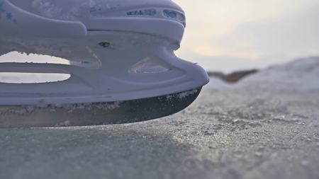 teen girl skating on ice, winter sunset beautiful view, holidays winterの写真素材