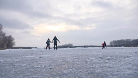 People skate on skating rink in sports the winter on ice, active winter holiday familyの写真素材