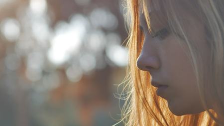 close up a girl smiling in the sunの写真素材