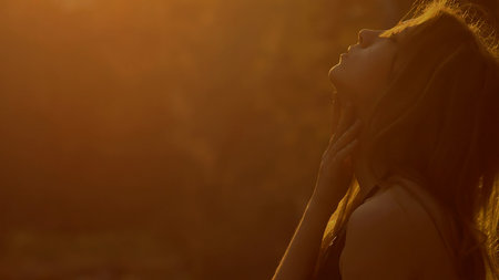 girl stroking his shoulders sexy at sunsetの写真素材