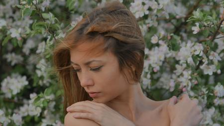 girl on the background face close up of apple blossomの写真素材