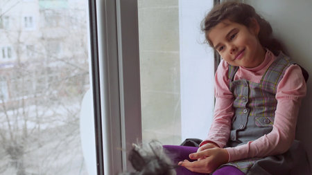 girl teen and dog sitting on a pet window sill windowsill