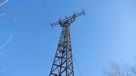 high-voltage tower against a blue sky Electricity wires technology