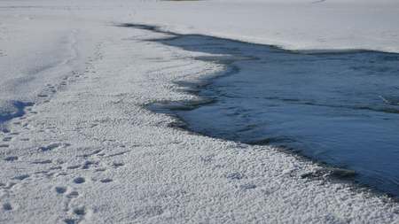 river winter ice snow, flowing blue water flow, of a winter nature landscapeの写真素材