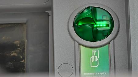 Card light flashing on ATM machineの写真素材