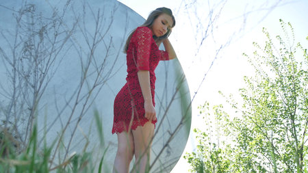 sexy girl. serious sexy girl stands near barrel of petrol oil. An oil old barrel