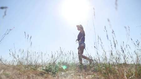 travel. Girl Young woman arms raised enjoying the fresh air in grass nature sunlightの写真素材