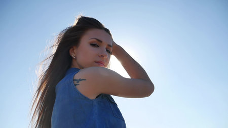 Sexy beautiful girl. Beautiful girl lifestyle in denim shorts summer nature travel in the wind...