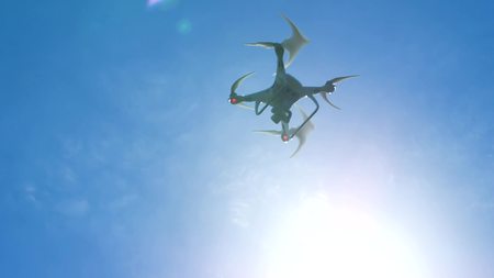 Quadcopter flies in the air. Radio-controlled helicopter quadcopter flies in skyの写真素材