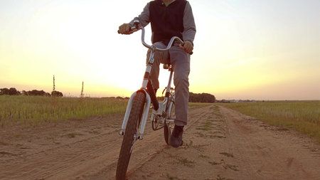 Boy teenager riding a bicycle. Boy teenager riding a bicycle goes to nature along path steadicam...