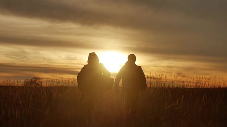 people go group travel of tourists field nature of sunset silhouette two people travel. tourists nature people group lifestyle goの写真素材