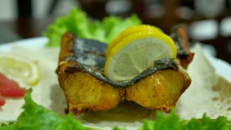 Dish of fish. Fried shark eating on a plate with lemon. Lunch at cafe restaurantの写真素材