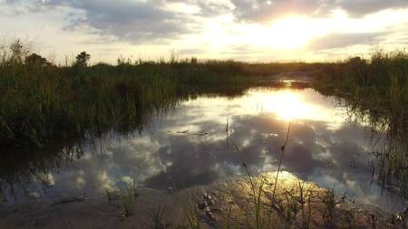 Nature landscape lake reflection of clouds in the water sunset sunlightの写真素材
