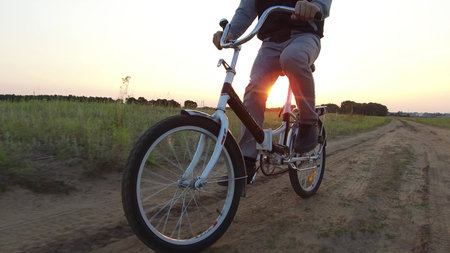 Boy teenager riding a bicycle. Boy teenager riding bicycle goes to nature along the path steadicam...
