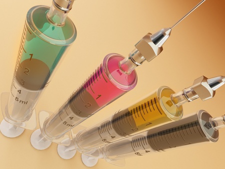 Four syringe with paints. CMYK. Conceptual images. 3dの写真素材