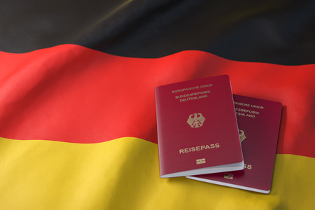 Passport of Germany on the flag of the Germany. Getting a Germnay passport,  naturalization and immigration concept. 3d illustrationの写真素材