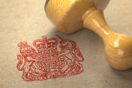 United Kingdom coat of arms stamp with rubber stamp on craft paper.