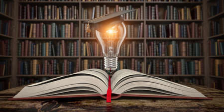 Education, knowledge and innovation concept background. Light bulb with mortar board on open book in vintage library. 3d illustrationの写真素材