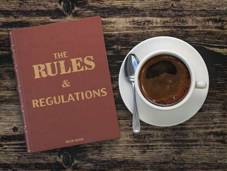 Rules and regulation book and cofee cup on wooden table. Comlience. 3d illustrationの写真素材
