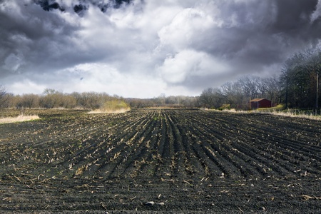 Black Ground with stormy sky and fog at duskの写真素材