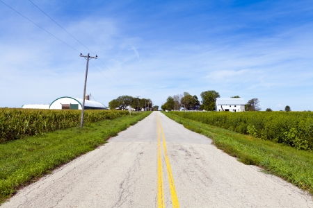 American Countryside Road With Farm Buildingsの写真素材