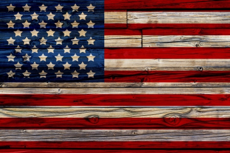 Old Painted American Flag on Dark Wooden Fence の写真素材