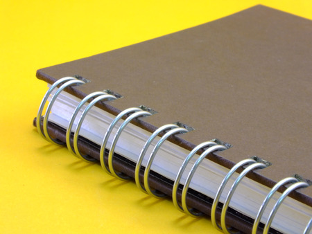notebook on yellow backgroundの写真素材