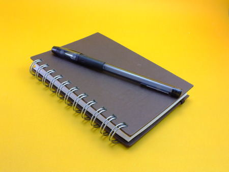 notebook on yellow backgroundの写真素材
