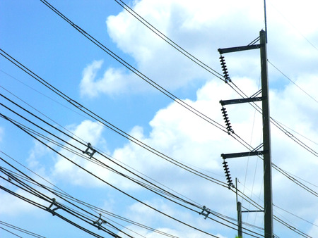 power line pylon against a blue skyの写真素材