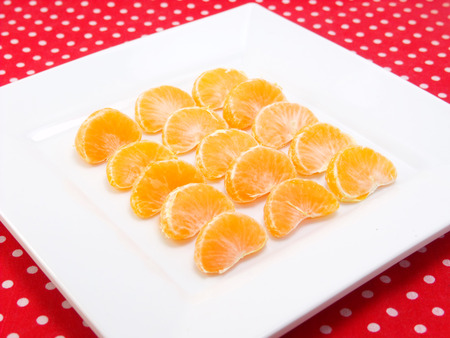 orange on white plateの写真素材