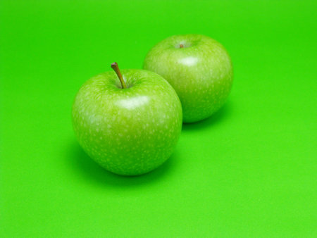 green apple on green backgroundの写真素材