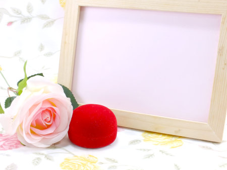 wood frame ande pink roses with red velvet box on sweet backgroundの写真素材