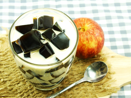 milk tea with black jelly in clear glass on white backgroundの写真素材