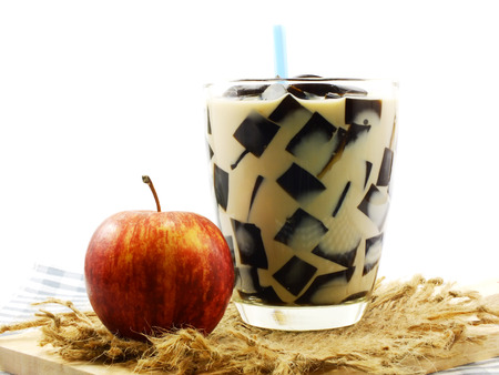 milk tea with black jelly in clear glass on white backgroundの写真素材