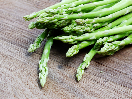 green raw asparagus on wooden table backgroundの写真素材
